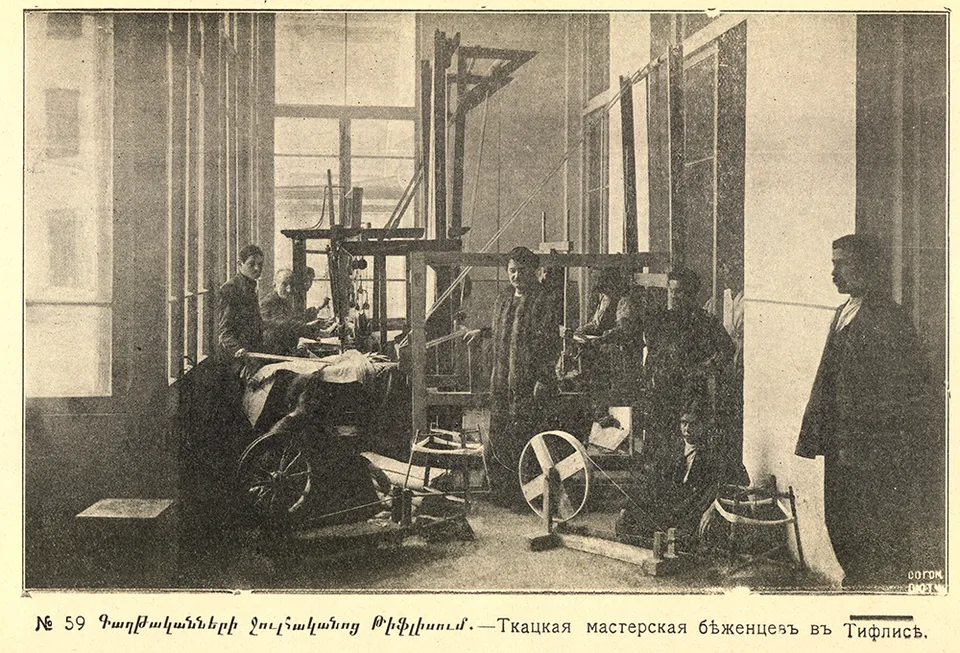 People inside a room containing looms