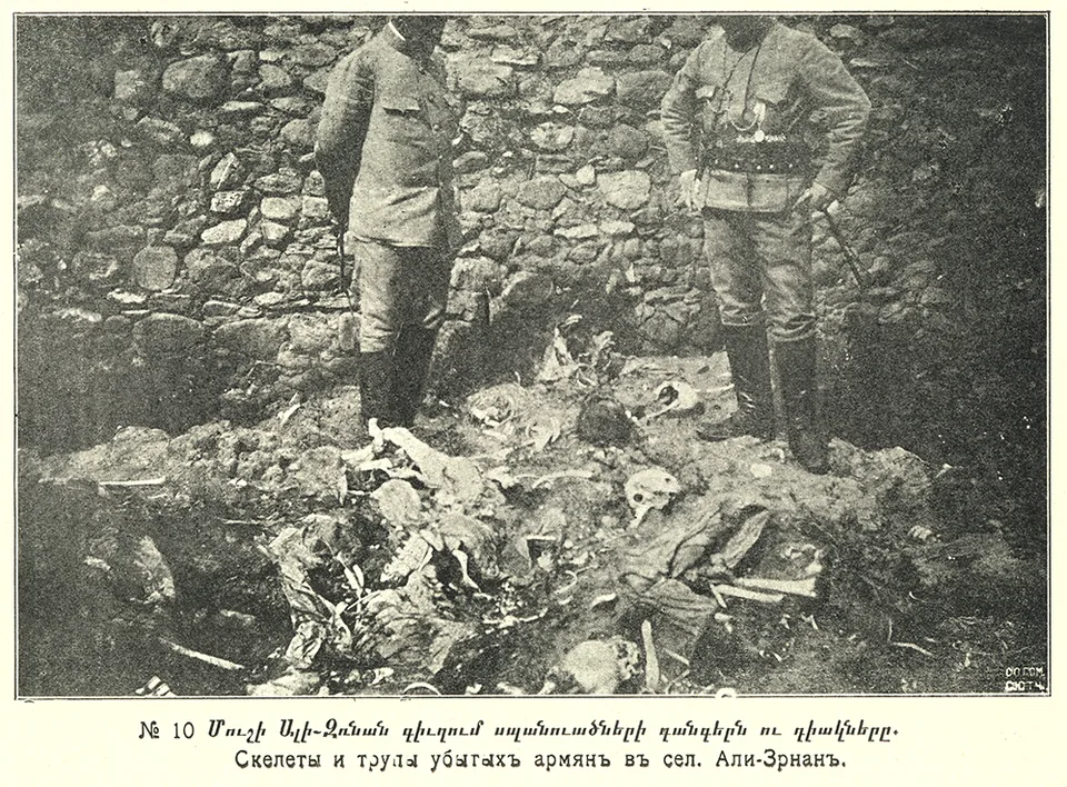 Skeletons and bodily remains on the ground beside stonework