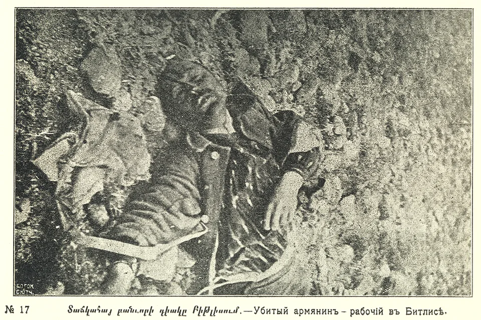 A clothed man’s body lies on the ground