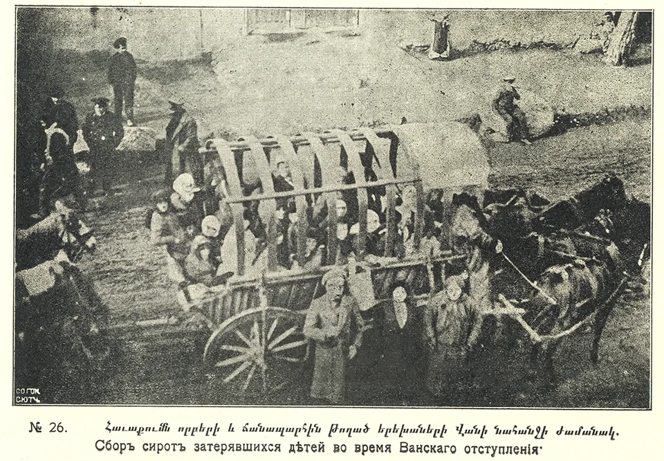Children sit in a wagon, with adults and a horse beside them