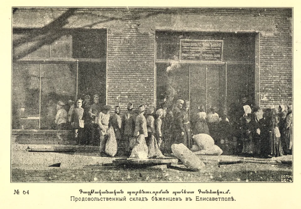 People stand outside a warehouse entrance beside large sacks
