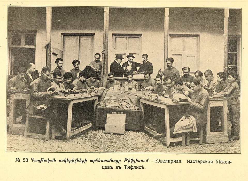 People work at benches in a jewellery workshop