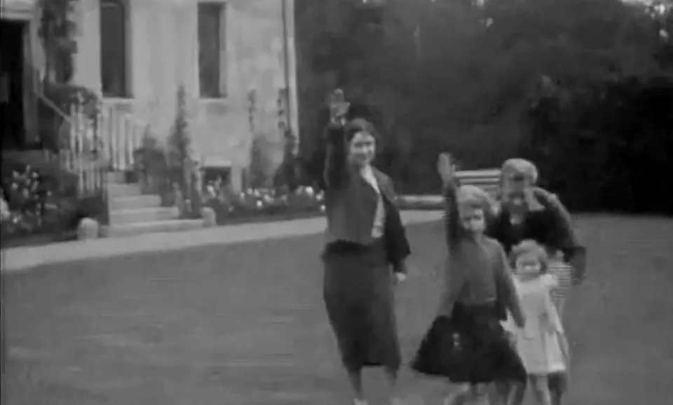 Processed film still of Elizabeth and Margaret with their mother and uncle Edward on the Balmoral lawn