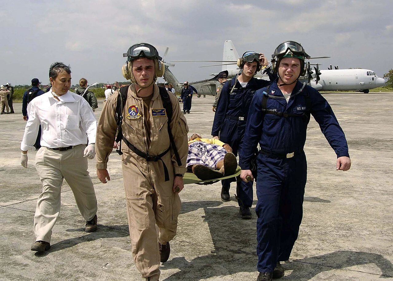 A survivor is carried from a helicopter to a medical tent. Aceh, 3 January 2005.