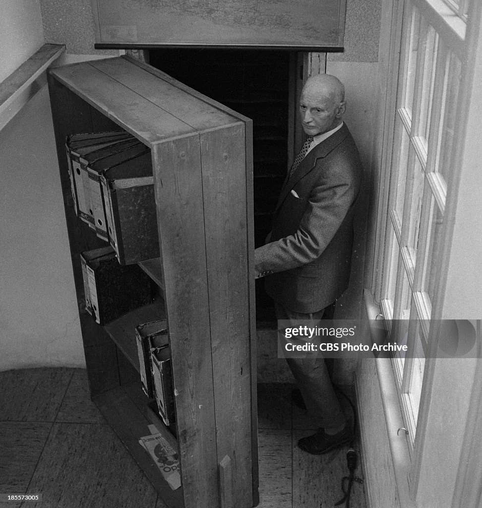 Otto Frank opens the bookcase concealing the Secret Annex. Amsterdam, July 1964.