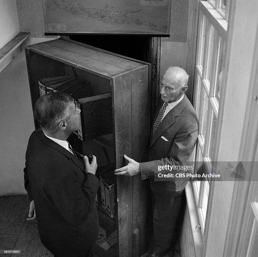 Otto Frank demonstrates the entrance to the Secret Annex. Amsterdam, July 1964.