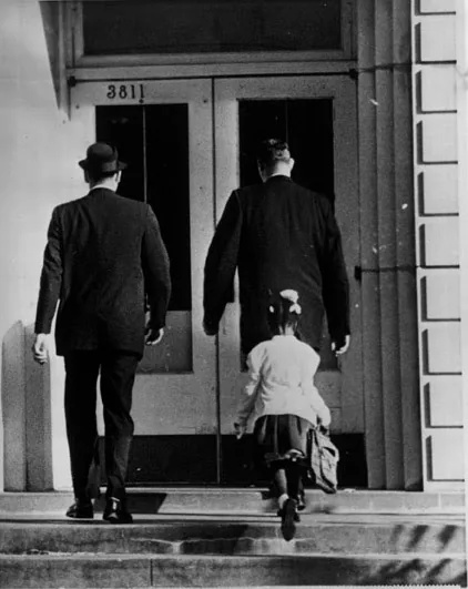 Ruby Bridges enters William Frantz with federal marshals. New Orleans, 28 November 1960, according to the Amistad archive.