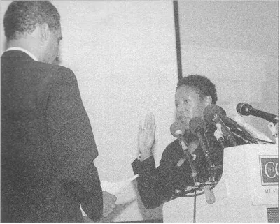 Eric Holder administers the oath to Ruby Bridges as an honorary deputy US marshal at the Corcoran Gallery in Washington, 10 August 2000.