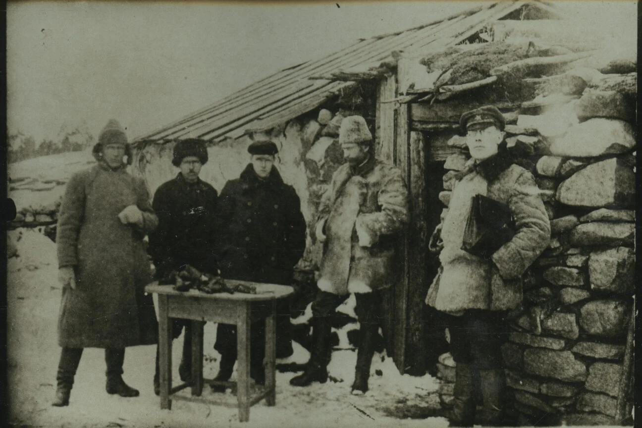 A group beside human remains. The Chelyabinsk album identifies them as people recording a crime. 1921-1922.