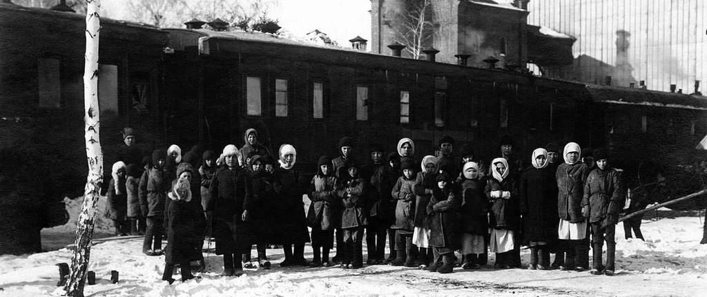 People beside a train used for evacuating children. Chelyabinsk, 1922.