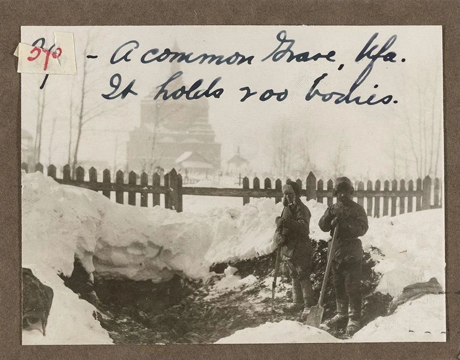 People beside a common grave in Ufa. Its archival inscription states that it holds 200 bodies. Winter 1922.