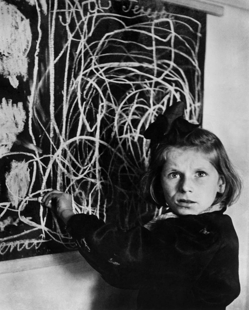 Tereska stands at a blackboard filled with a tangle of chalk lines. Photograph by David “Chim” Seymour / Magnum Photos, Warsaw, 1948.